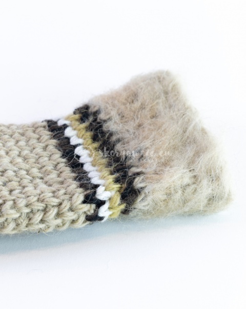 Woolen, cream mittens with brown, black and white stiching