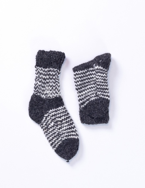 High, thick, white socks with wool filling with a gray, highlander pattern